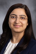 A headshot of Nidhi Madan